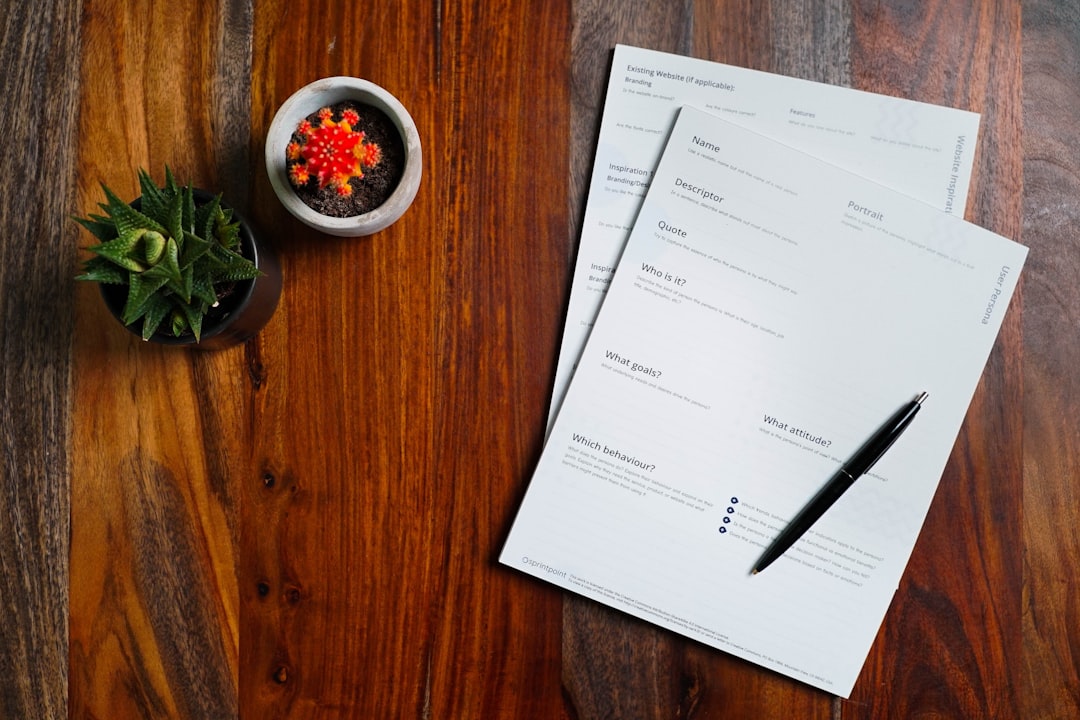 A blank disclosure form and a pen on a wooden table, ready for an Illinois home seller to complete