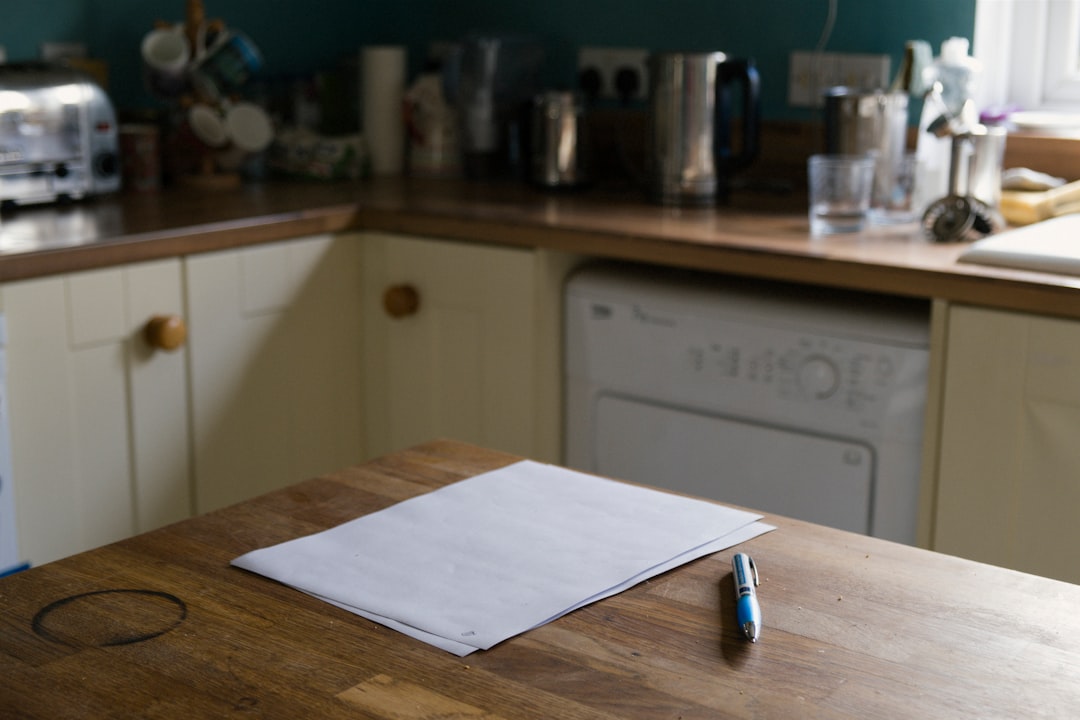 A sheet of paper and a pen on a kitchen table, ready for notes before a listing appointment