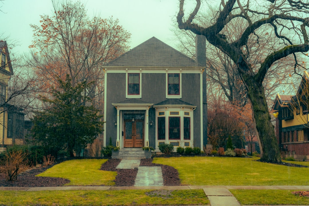 A two story house with a front walk and mature trees, the kind of home covered by the Illinois disclosure report